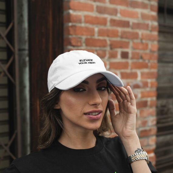 Woman wearing white Elevate Dad Hat