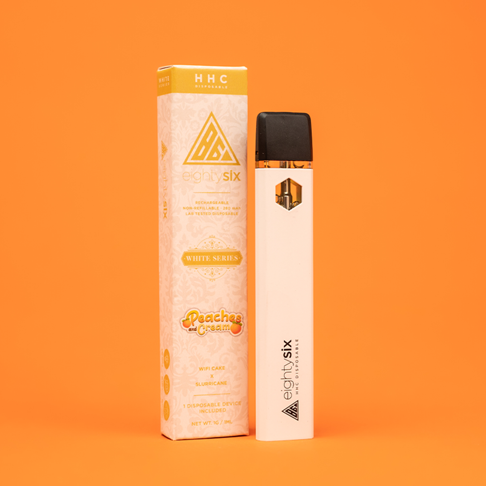14 Peaches & Cream HHC Disposable with its respective box on an orange background.