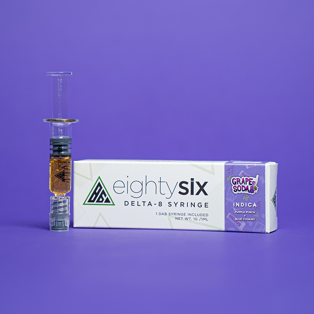 31 Grape Soda Delta-8 THC Syringe with its respective box on a purple background.