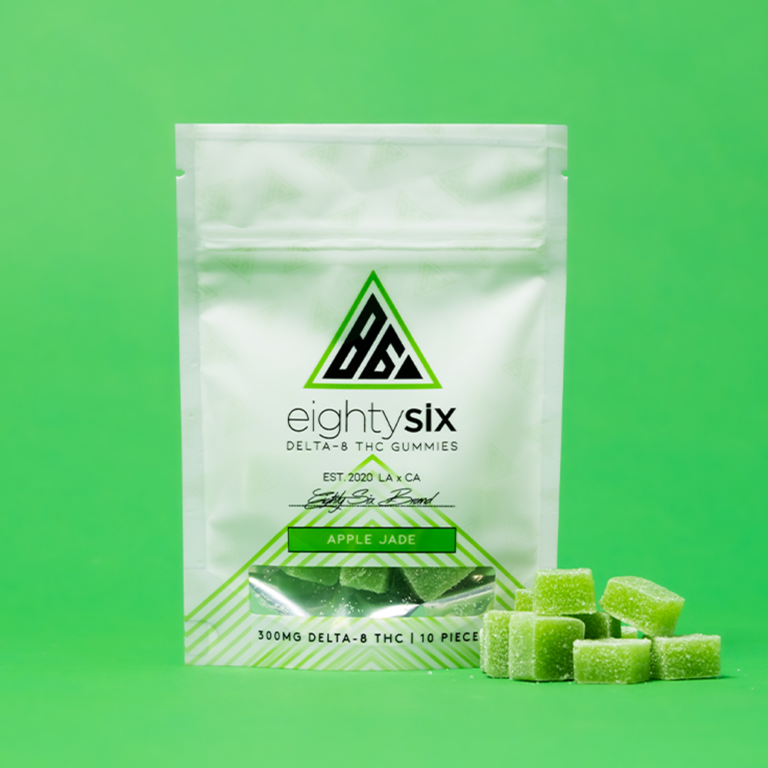 Apple-Jade-Delta-8-THC-Gummies-with-its-respective-mylar-bag-on-a-green-background