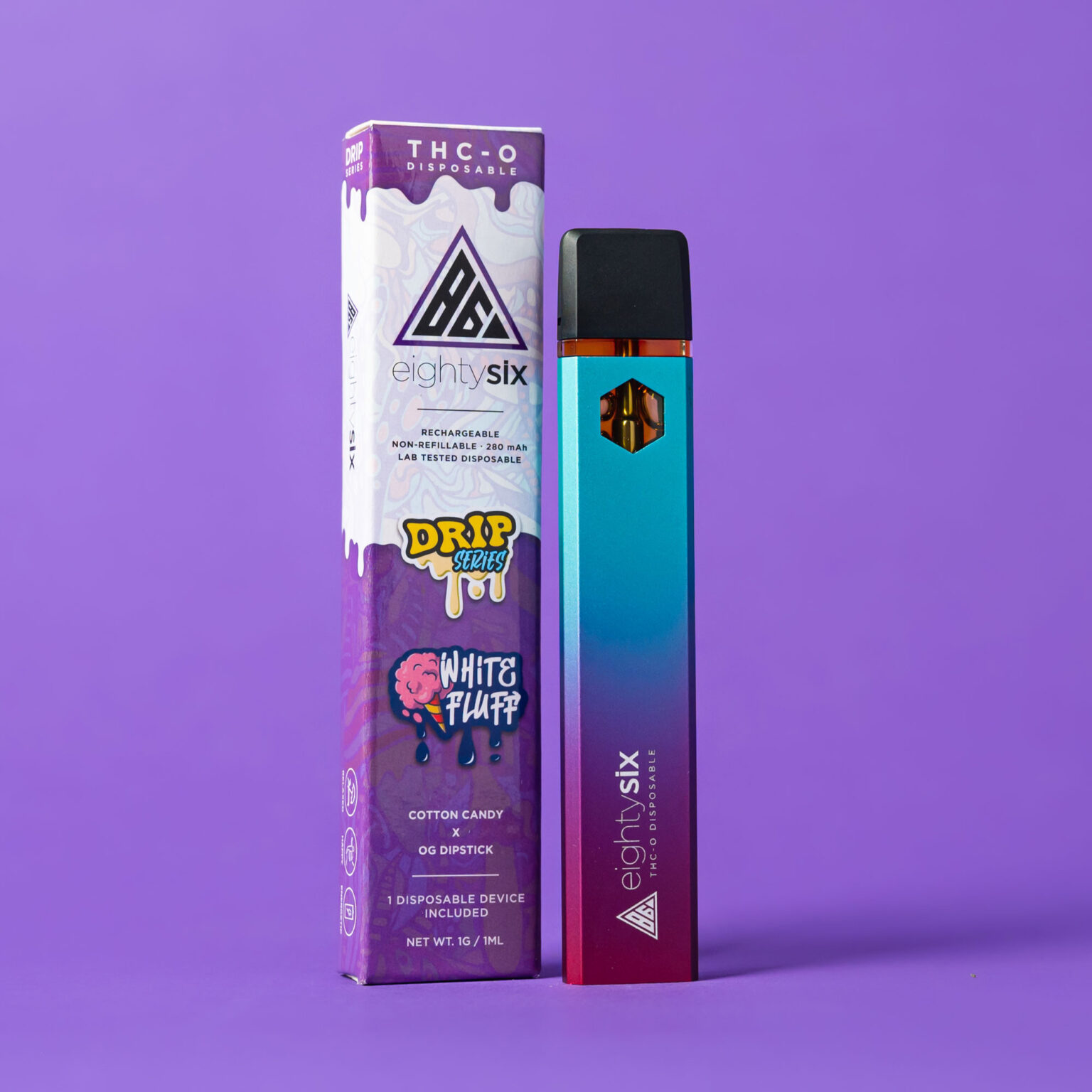 White-Fluff-THC-O-Disposable-with-box-on-purple-background White Fluff THC-O Disposable with its respective box on a purple background.