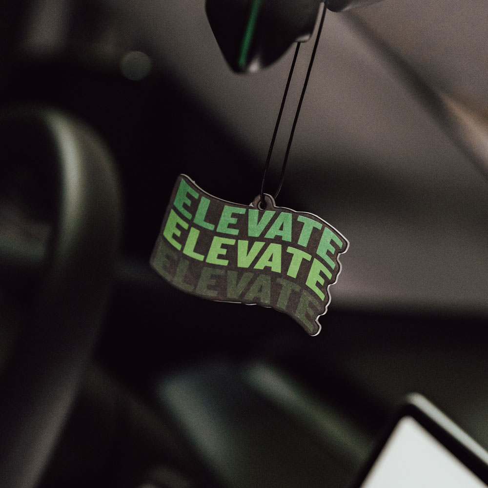 Apple Blast Air Freshener The Apple Blast Air Freshener hanging on the rearview mirror of a Tesla Model 3
