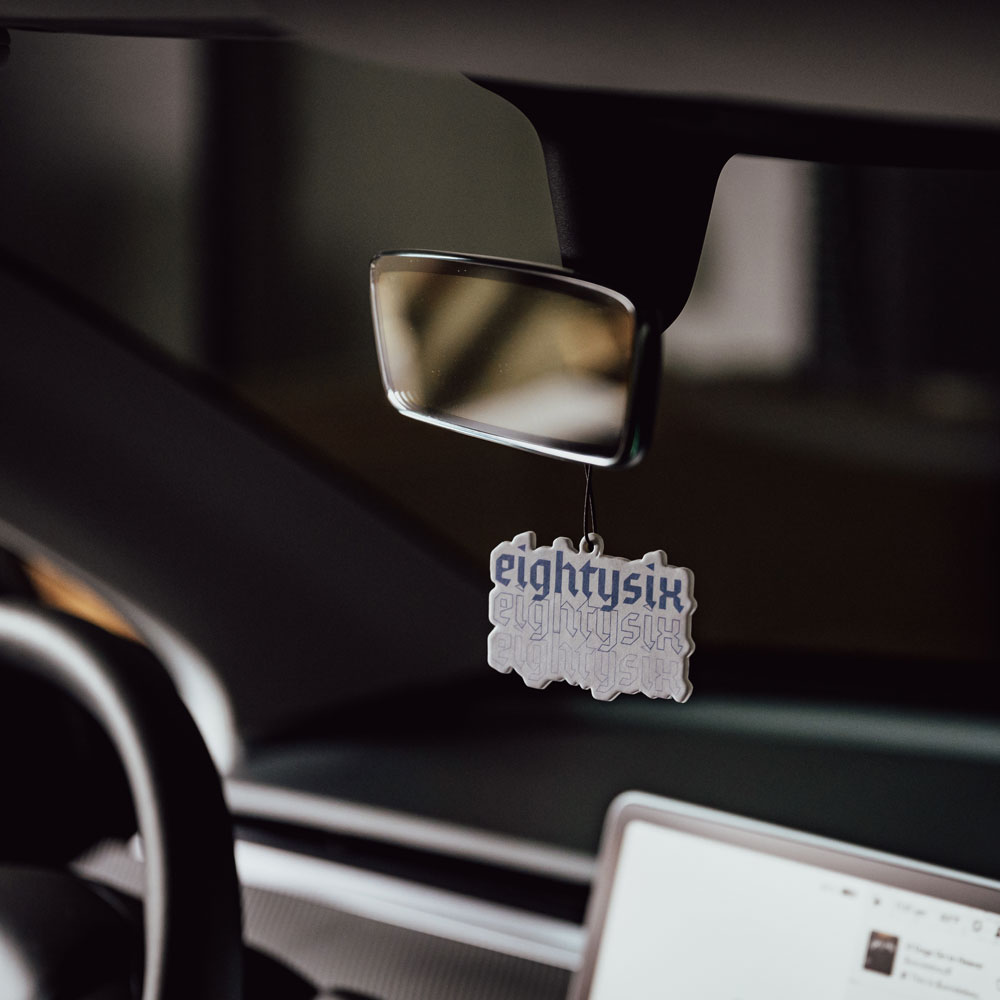 Ocean Wave Air Freshener The Ocean Wave Air Freshener hanging from the rearview mirror of a Tesla Model 3