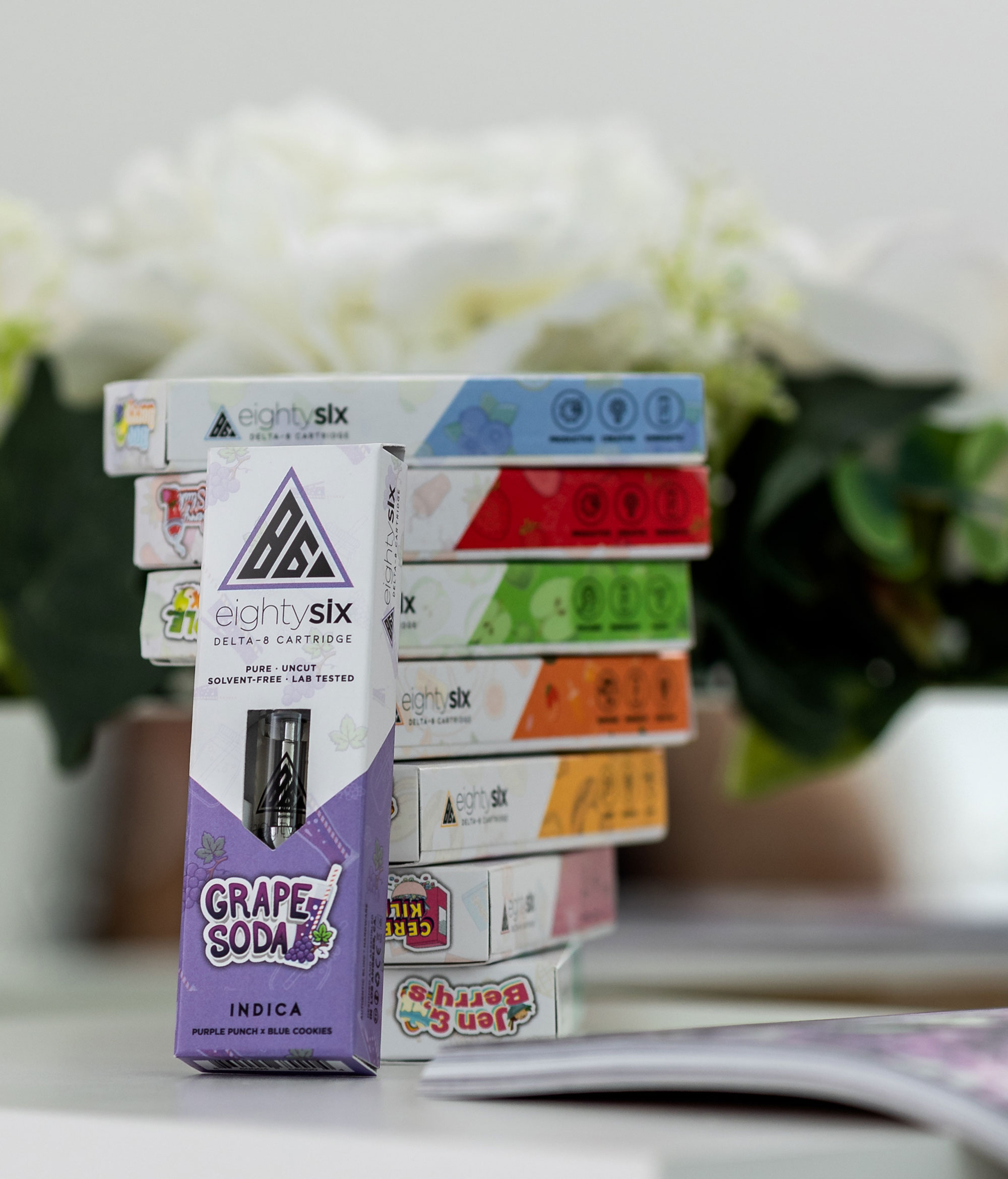 Grape Soda Delta-8 THC Vape Cartridge leaning on the rest of the product collection series.