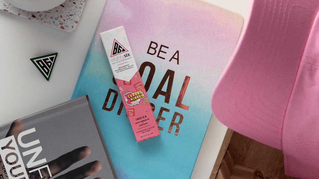 Delta-8 Cereal Killer disposable vape with pinkish background and supplies